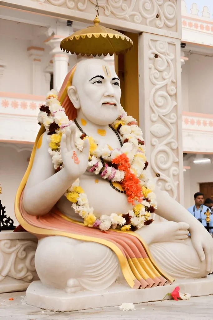 The image shows a statue of Sri Guru Raghavendra Swami.