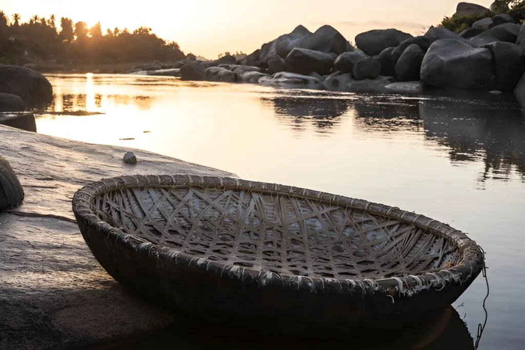 The image shows a traditional, circular boat called a coracle on the Tungabhadra River in Hampi, India.