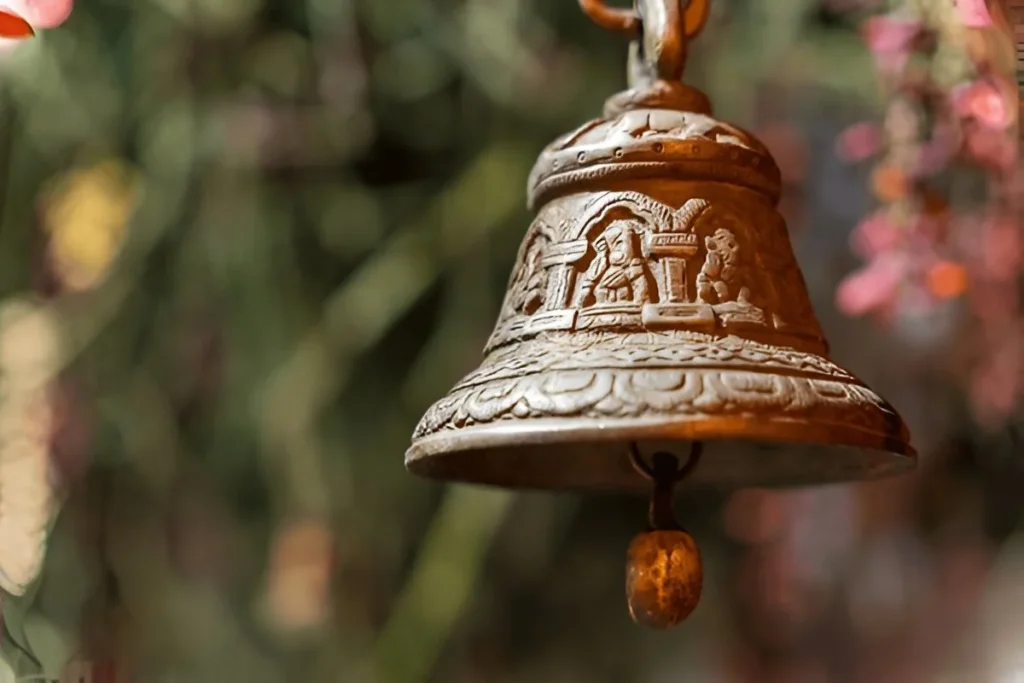 This is an old bronze temple bell with intricate carvings.