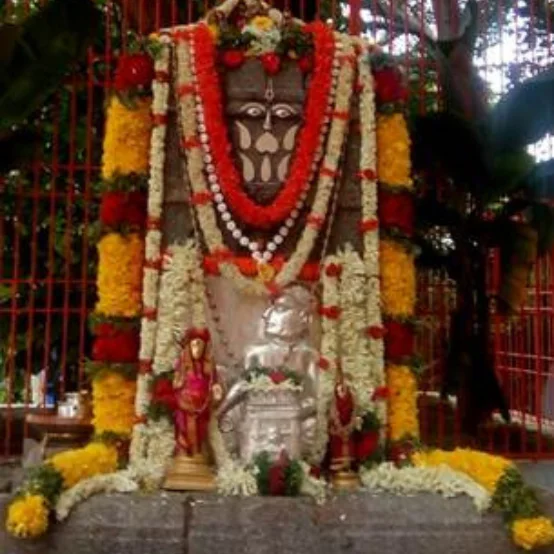 The image shows an altar dedicated to the Hindu saint Sri Guru Raghavendra Swamy, likely located at the Sri Raghavendra Swamy Matha in Mantralayam or the nearby village of Bichali, also known as Bikshalaya.